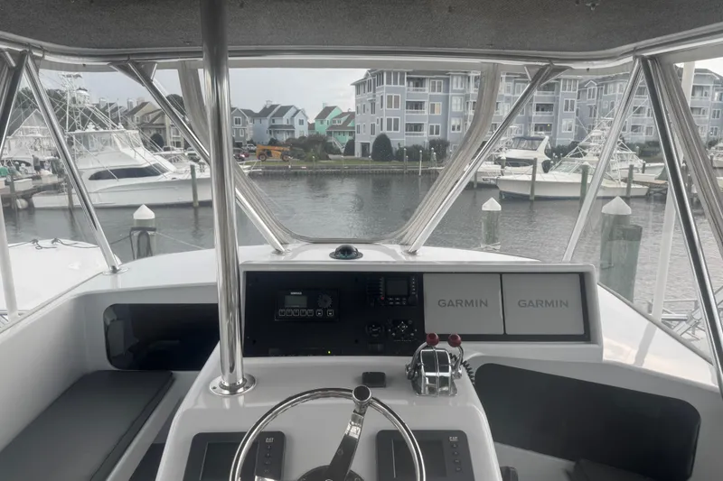 Slide: The Image of Helm of 1990 Buddy Cannady 57 Custom Carolina boat with Garmin navigation, docked in marina. - 8