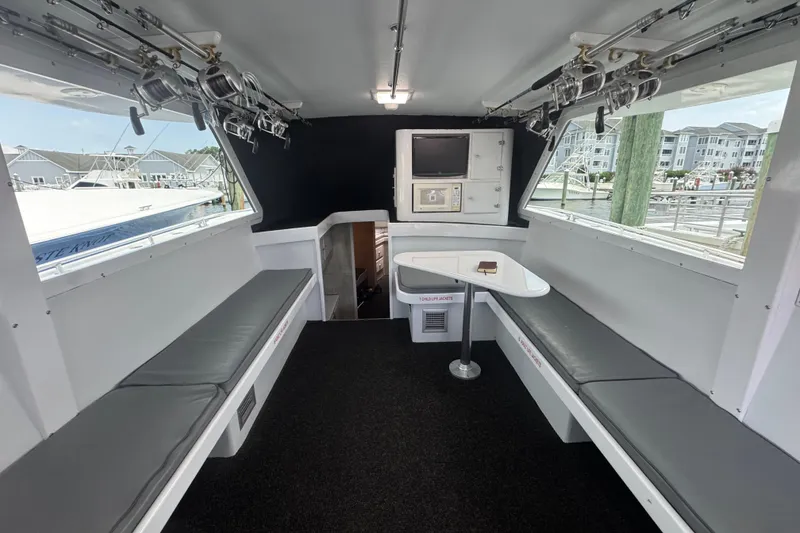 Slide: The Image of Interior of 1990 Buddy Cannady 57 Custom Carolina boat with seating and fishing rods. - 10