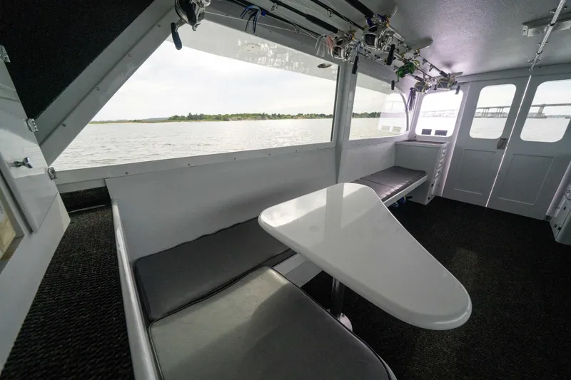Slide: The Image of Interior of 1990 Custom Carolina 57 Buddy Cannady boat with seating and table, overlooking water. - 21