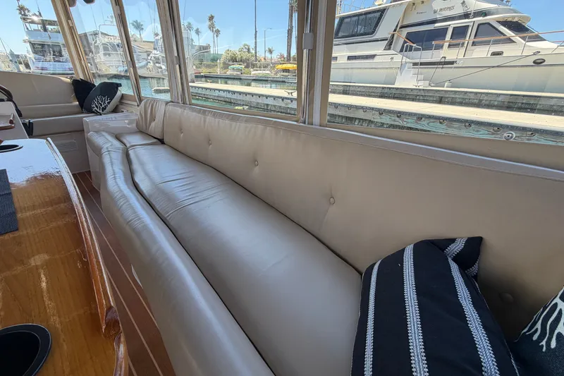 Slide: The Image of Interior of a 2005 Duffy Classic 21 boat with beige seating and decorative pillows. - 16