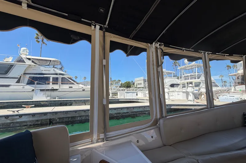 Slide: The Image of Interior view from a 2005 Duffy Classic 21 boat, overlooking a marina with yachts. - 22