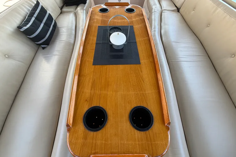 Slide: The Image of Luxurious interior of 2005 Duffy Classic 21 boat with wooden table and cup holders. - 15