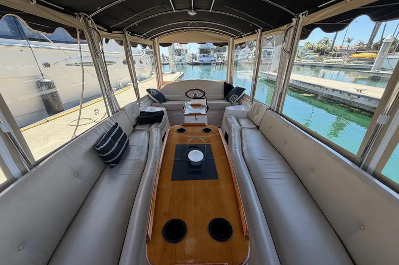 Slide: The Image of Interior of a 2005 Duffy Classic 21 boat with elegant seating and wooden table. - 13