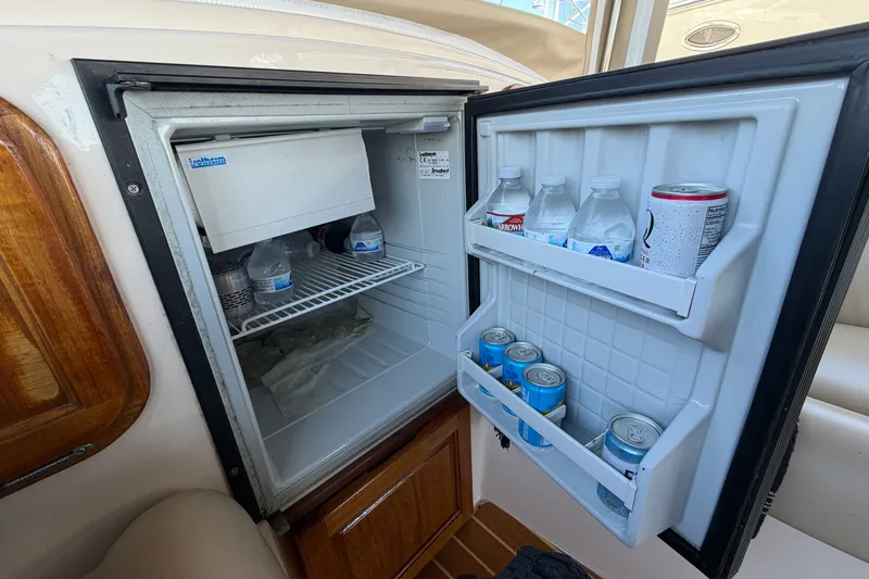 Slide: The Image of Open fridge on 2005 Duffy Classic 21 boat, stocked with drinks and water bottles. - 18