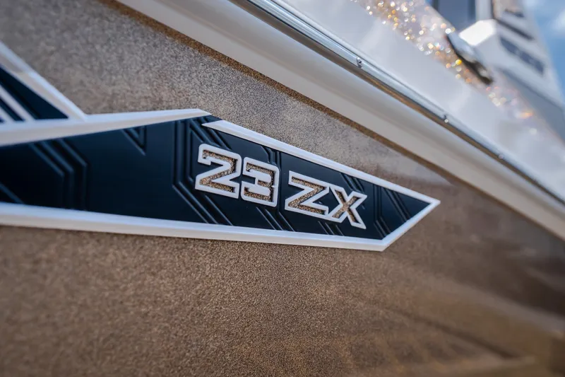 Slide: The Image of 2027 Tigé Ultré 23ZX boat emblem on metallic finish. - 17