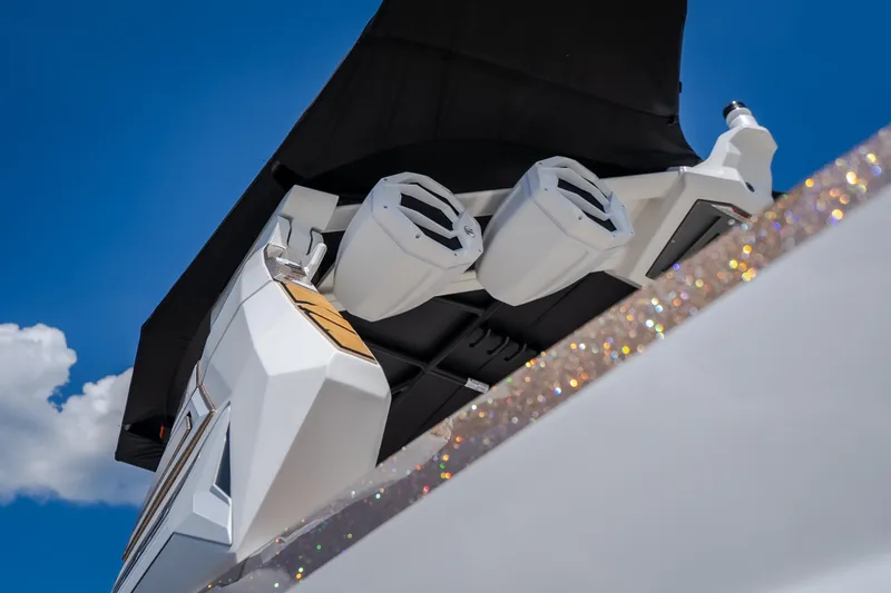 Slide: The Image of 2027 Tigé Ultré 23ZX boat speakers against a clear blue sky. - 19