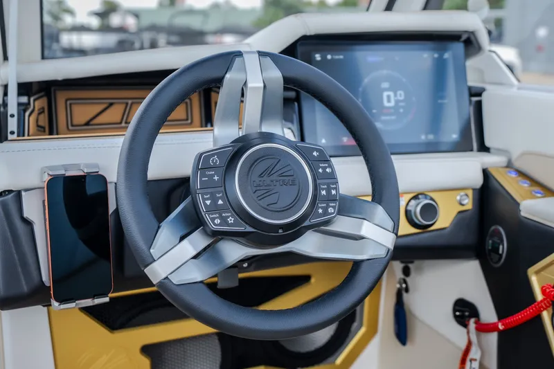 Slide: The Image of Steering wheel and dashboard of 2027 Tigé Ultré 23ZX boat with touchscreen display. - 36