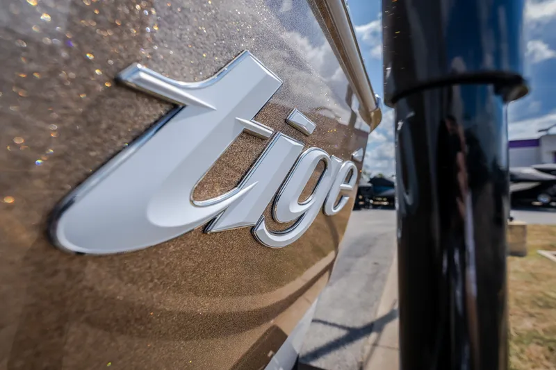 Slide: The Image of Close-up of 2027 Tigé Ultré 23ZX boat logo with metallic finish. - 18