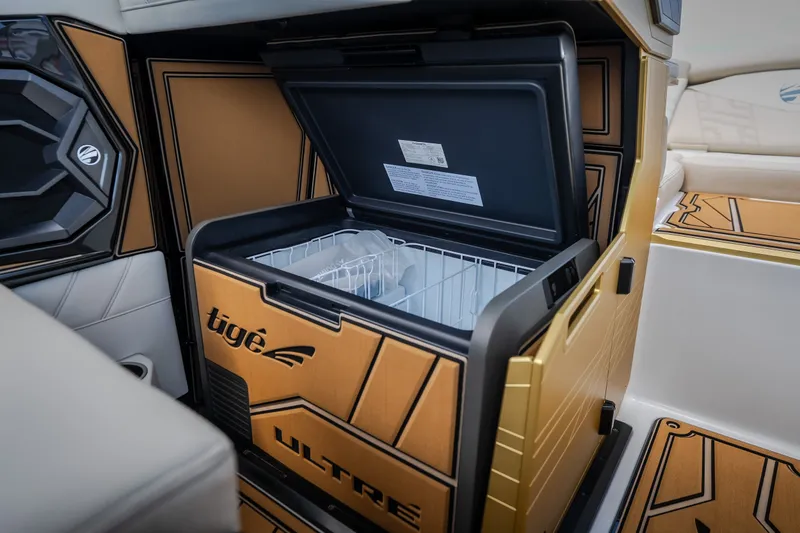 Slide: The Image of 2027 Tigé Ultré 23ZX boat interior with open built-in cooler. - 44