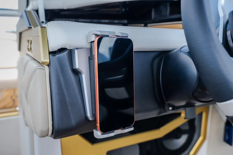 Slide: The Image of 2027 Tigé Ultré 23ZX dashboard with integrated smartphone holder and steering wheel. - 37