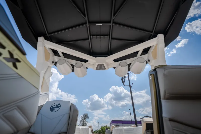 Slide: The Image of Interior view of 2027 Tigé Ultré 23ZX boat with speakers and seating under a canopy. - 55