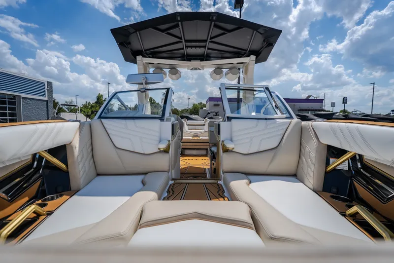 Slide: The Image of 2027 Tigé Ultré 23ZX boat interior with luxurious seating and modern design under a blue sky. - 15