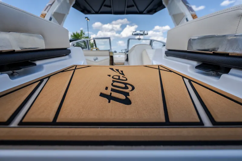 Slide: The Image of 2027 Tigé Ultré 23ZX boat interior with logo, showcasing luxury seating and design. - 27