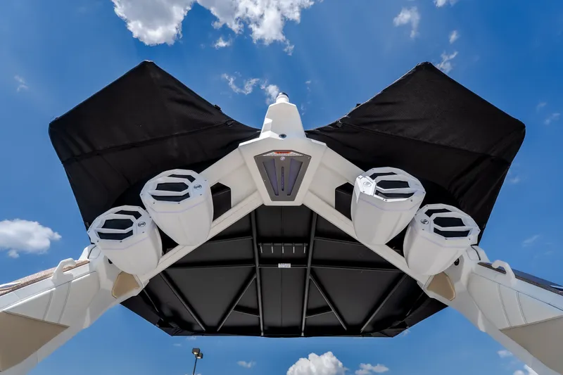 Slide: The Image of 2027 Tigé Ultré 23ZX boat speakers and canopy under a clear blue sky. - 32