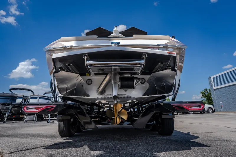 Slide: The Image of Rear view of 2027 Tigé Ultré 23ZX boat on trailer under clear blue sky. - 22