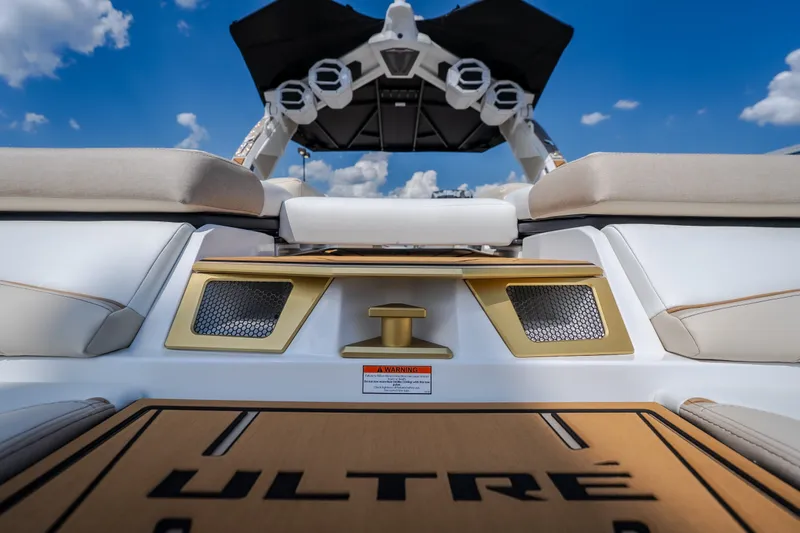 Slide: The Image of 2027 Tigé Ultré 23ZX boat interior with cushioned seating and sleek design. - 24