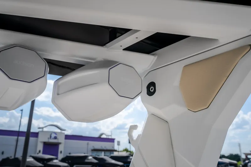 Slide: The Image of 2027 Tigé Ultré 23ZX boat speakers and interior detail under a clear sky. - 56