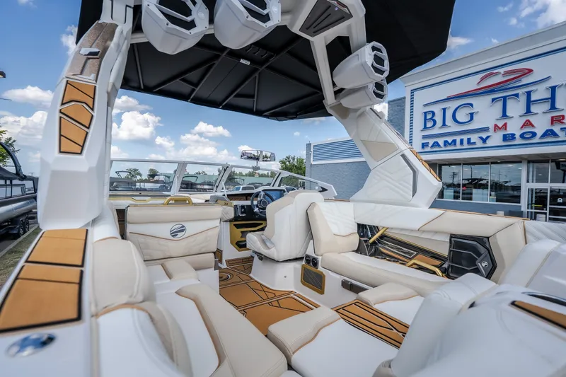 Slide: The Image of 2027 Tigé Ultré 23ZX boat interior with luxurious seating at a family boat dealership. - 31