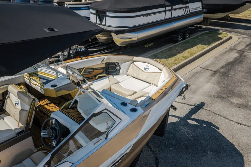 Slide: The Image of 2027 Tigé Ultré 23ZX boat with luxurious interior, parked on a trailer. - 73