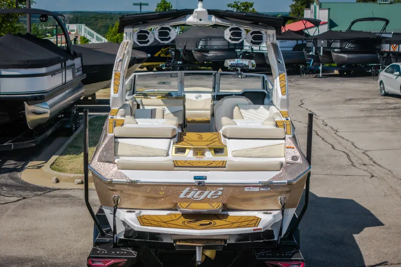 Slide: The Image of 2027 Tigé Ultré 23ZX boat with luxurious seating and modern design in a showroom. - 21