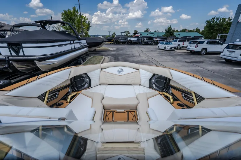 Slide: The Image of 2027 Tigé Ultré 23ZX boat interior with luxurious seating at a marina. - 68