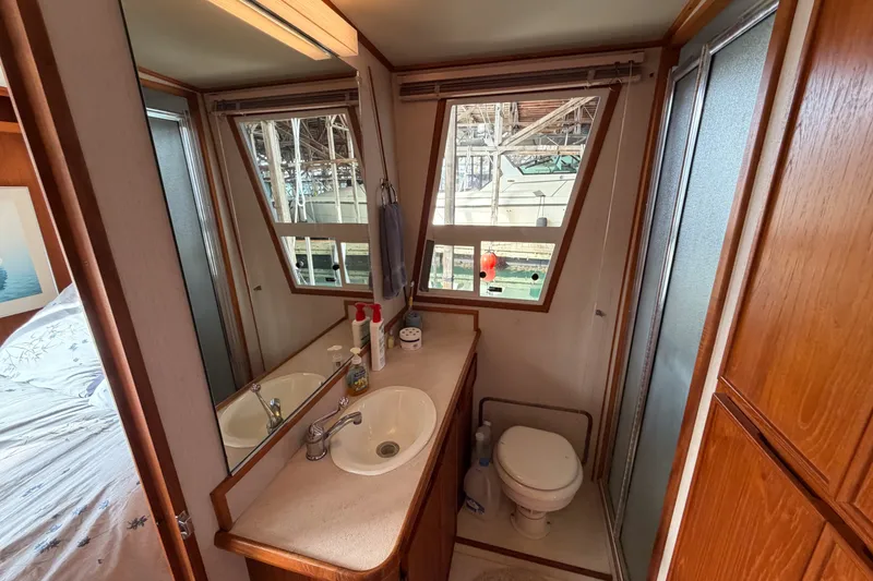 Slide: The Image of Bathroom interior of a 1990 Cruise-A-Home Corsair with sink, toilet, and shower. - 34