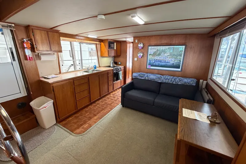 Slide: The Image of Interior of 1990 Cruise-A-Home Corsair with kitchen, sofa, and wooden cabinetry. - 50