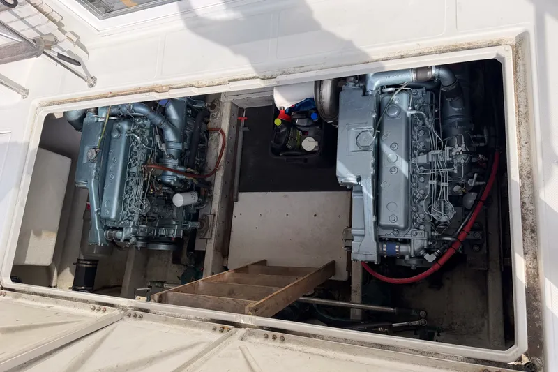 Slide: The Image of Engine compartment of a 1990 Cruise-A-Home Corsair boat, featuring dual engines. - 24