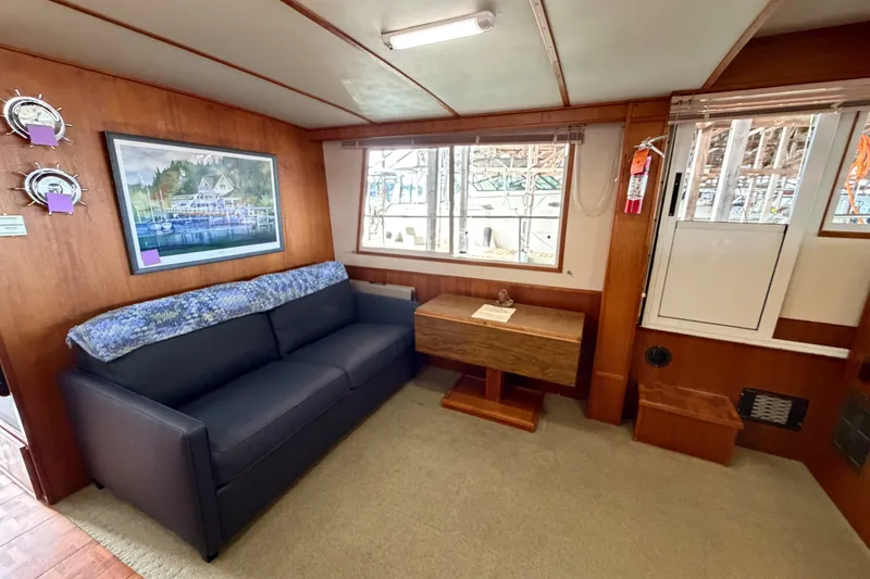 Slide: The Image of Interior of 1990 Cruise-A-Home Corsair with sofa, artwork, and wooden table. - 51