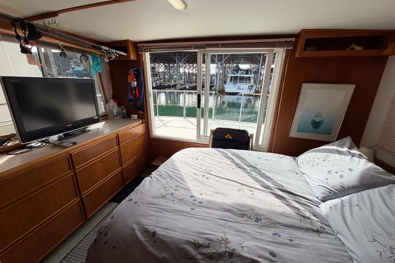 Slide: The Image of Cozy bedroom interior of 1990 Cruise-A-Home Corsair with waterfront view and TV. - 32