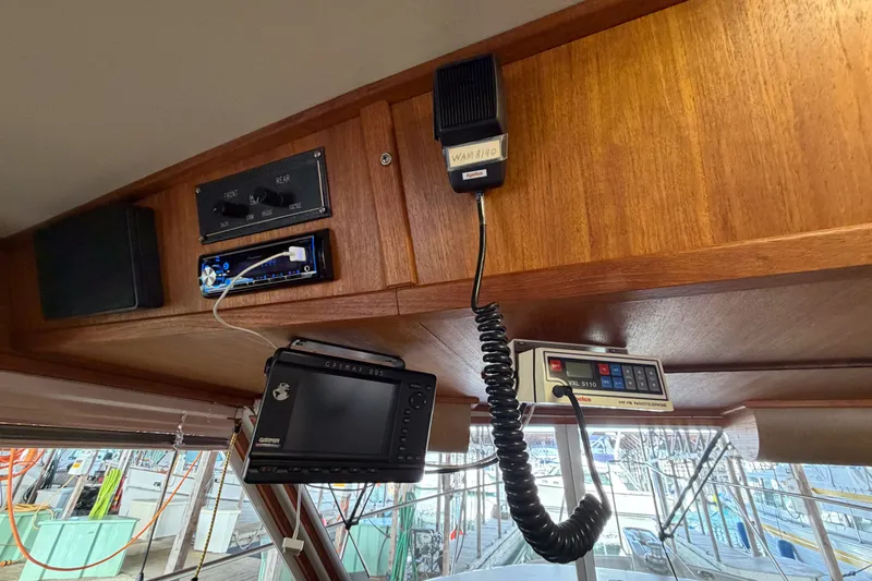 Slide: The Image of Interior of 1990 Cruise-A-Home Corsair with navigation equipment and communication devices. - 49