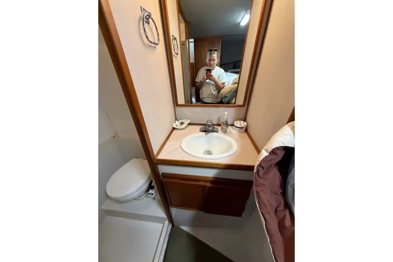 Slide: The Image of Bathroom interior of 1990 Cruise-A-Home Corsair with sink, mirror, and toilet. - 67