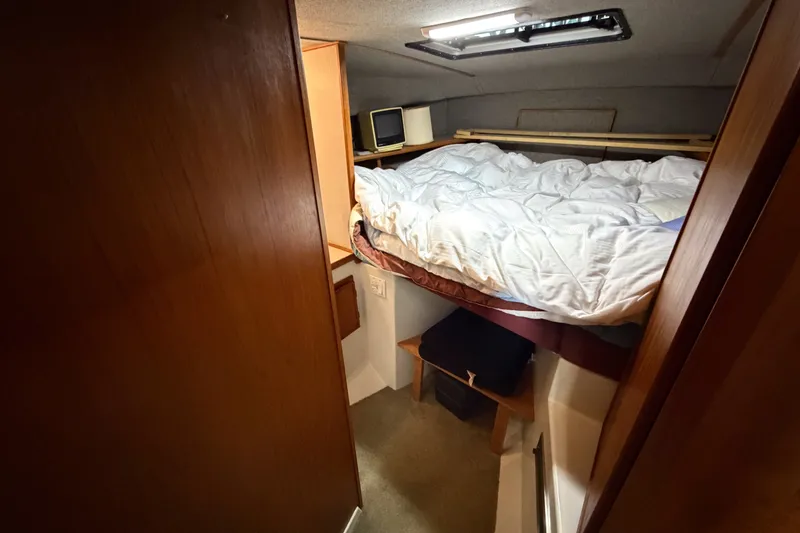 Slide: The Image of Cozy cabin interior of 1990 Cruise-A-Home Corsair with bed and storage. - 61