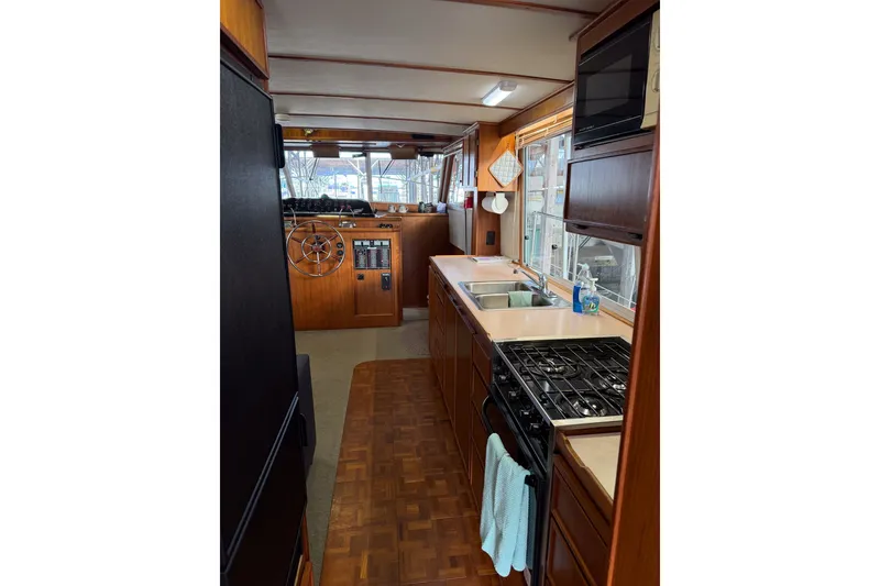 Slide: The Image of Interior of a 1990 Cruise-A-Home Corsair boat with kitchen and steering area. - 41