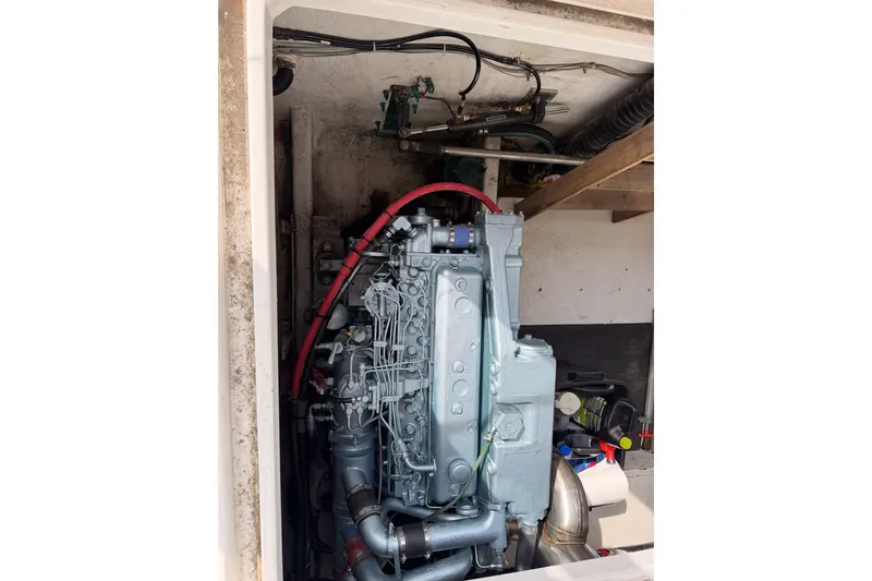 Slide: The Image of Engine compartment of a 1990 Cruise-A-Home Corsair boat, showcasing mechanical components. - 25