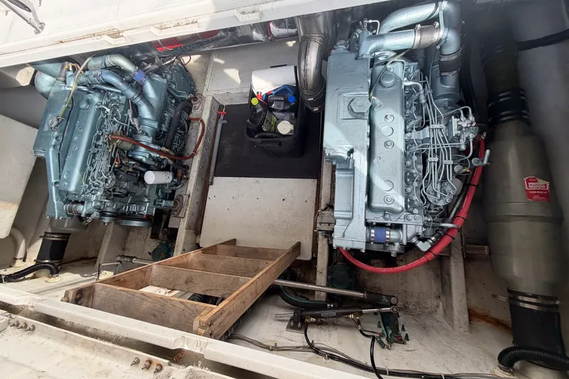 Slide: The Image of Engine compartment of a 1990 Cruise-A-Home Corsair with dual engines and maintenance tools. - 23