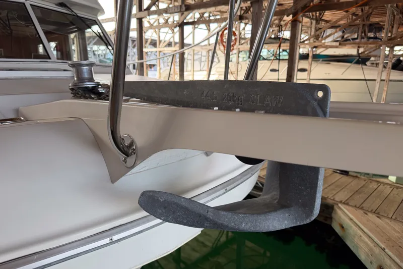 Slide: The Image of Anchor on 1990 Cruise-A-Home Corsair boat docked in marina. - 74