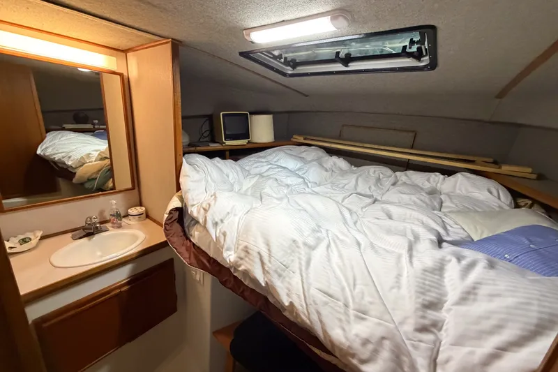Slide: The Image of Cozy cabin interior of 1990 Cruise-A-Home Corsair with bed and sink. - 63