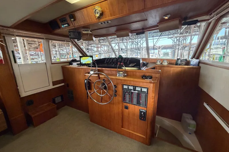 Slide: The Image of Interior helm of 1990 Cruise-A-Home Corsair with wooden dashboard and steering wheel. - 53