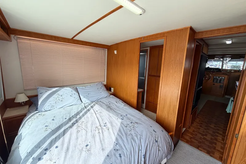 Slide: The Image of Cozy bedroom interior of 1990 Cruise-A-Home Corsair boat with wooden paneling and natural light. - 31
