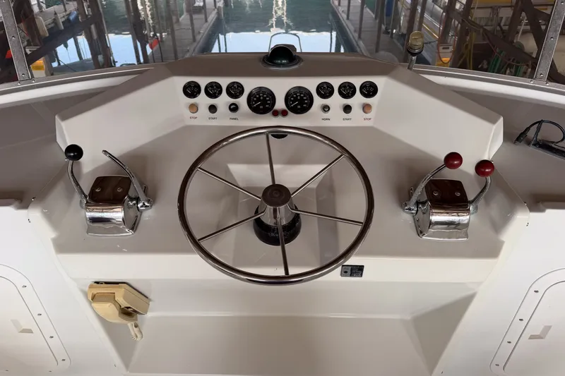Slide: The Image of Steering console of a 1990 Cruise-A-Home Corsair boat with controls and gauges. - 15