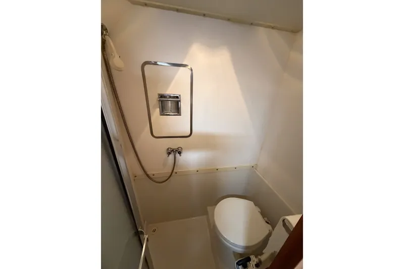 Slide: The Image of Compact bathroom in 1990 Cruise-A-Home Corsair boat with toilet and shower. - 65