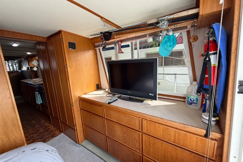 Slide: The Image of Interior of 1990 Cruise-A-Home Corsair with TV, wooden cabinets, and fishing gear. - 37