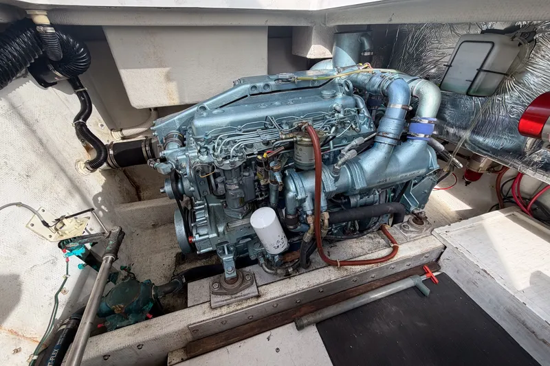 Slide: The Image of Engine compartment of a 1990 Cruise-A-Home Corsair boat, showcasing detailed machinery. - 18