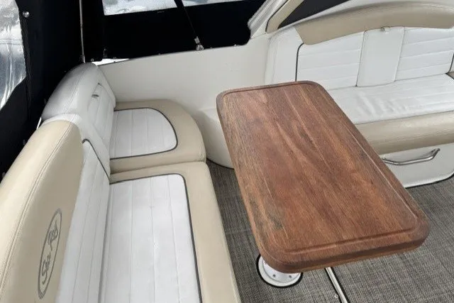Slide: The Image of Interior seating area of 2008 Sea Ray 290 Sundancer with wooden table. - 11