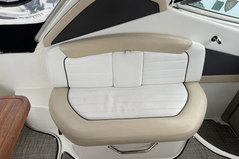 Slide: The Image of 2008 Sea Ray 290 Sundancer interior seating with beige and white upholstery. - 7