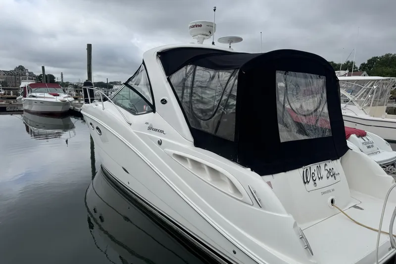 Slide: The Image of 2008 Sea Ray 290 Sundancer docked at a marina under cloudy skies. - 1