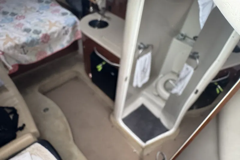 Slide: The Image of Interior of 2008 Sea Ray 290 Sundancer with bed and compact bathroom. - 12