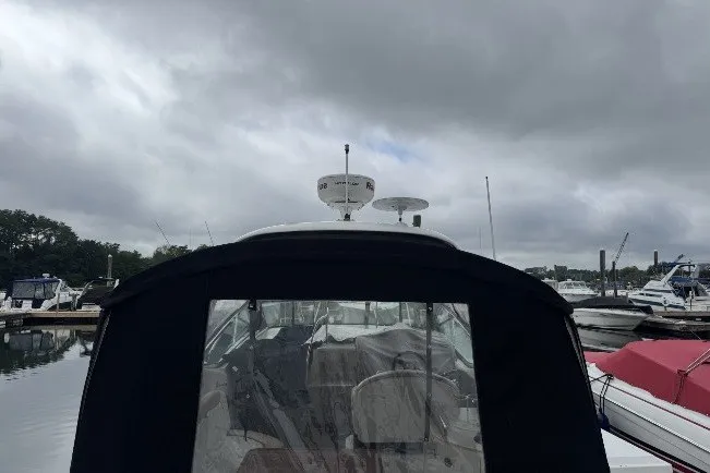 Slide: The Image of 2008 Sea Ray 290 Sundancer docked under cloudy skies at a marina. - 4