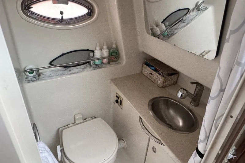 Slide: The Image of Compact bathroom in 2008 Sea Ray 290 Sundancer boat with sink, toilet, and storage. - 18